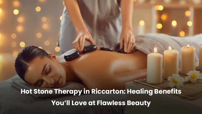Hot stone therapy treatment at Flawless Beauty in Riccarton – soothing warm stones placed on back for relaxation and healing